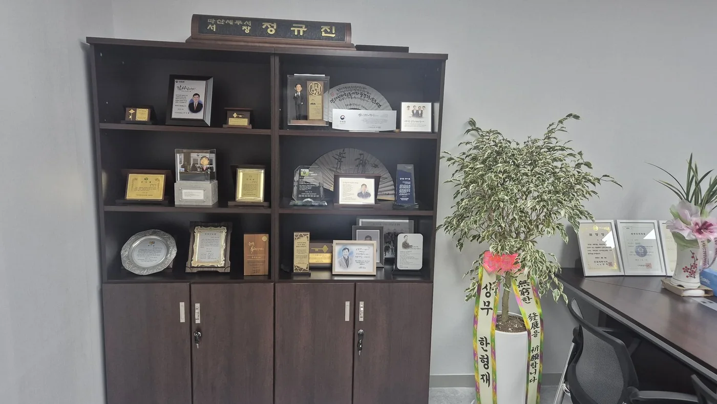 정규진 대표세무사의 상패와 경력 자료가 전시된 사무실 공간
